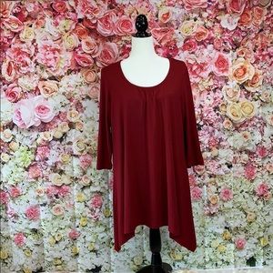 Burgundy tunic length, longer on sides & sleeves.